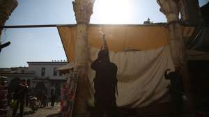 epa11766231 An armed rebel fires into the air at al-Hamidiyeh market, in Damascus, Syria, 09 December 2024. Syrian rebels entered Damascus on 08 December 2024 and announced in a televised statement the 'Liberation of the city of Damascus and the overthrow of Bashar al-Assad', as well as the release of all the prisoners.  EPA/BILAL ALHAMMOUD