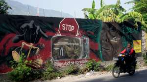 epa13195843 Motorcyclists ride past a mural in Port-au-Prince, Haiti, 27 August 2026. Haiti is preparing to hold elections in December, despite ongoing violence, including an attack on 24 August that killed at least 47 people, amid a wave of violence that claimed more than 3,000 lives in the first six months of the year, according to UN data.  EPA/Jonet St Elois