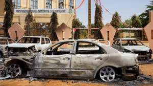epa10773372 Torched cars sit in front of the headquarters of the Nigerien Party for Democracy and Socialism, which was damaged during anti-government protests in Niamey, Niger, 29 July 2023. Mutinous soldiers calling themselves the 'National Council for the Safeguarding of the Country' claimed to have overthrown President Mohamed Bazoum, Niger's democratically elected president, in a televised address on 26 July evening. Protesters went out on 27 July in the streets of Niamey to support mutinous soldiers and demand the end of foreign intervention in the country. They also set fire to the building housing the headquarters of the ousted president's party.  EPA/ISSIFOU DJIBO
