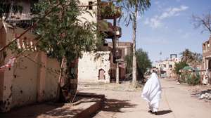 epa11700441 A woman walks along a street in Omdurman, Sudan, 01 November 2024 (issued 04 November 2024). On 02 November, Omdurman was under the control of the Sudanese Armed Forces. A civil war broke out April 2023 between the Sudanese military led by army chief Abdel Fattah al-Burhan, and the paramilitary Rapif Support Forces (RSF) led by Mohamed Hamdan Dagalo, the former Deputy Chairman of the Transitional Sovereignty Council of Sudan.The International Office for Migration (IOM) estimates that spme eight million people have been displaced internally or to neighbouring countries since April 2023.  EPA/Sara Creta