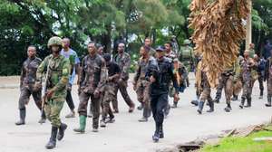 epa11856263 Surrendering members of the Armed Forces of the Democratic Republic of the Congo (FARDC) are escorted by Rwandan soldiers after crossing the border from Goma, in the Democratic Republic of the Congo, to Gisenyi, Rwanda, 27 January 2025. Refugees have been crossing into Rwanda in search of safety as soldiers of the Armed Forces of the Democratic Republic of the Congo (FARDC) and M23 rebels continue to fight in the city of Goma. According to the UN Refugee Agency (UNHCR), violence in the eastern Democratic Republic of the Congo (DRC) has displaced 237,000 people in 2025.  EPA/MOISE NIYONZIMA