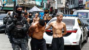 epa12487916 Rio de Janeiro Police officers transfer a group of people detained during an operation in Rio de Janeiro, Brazil, 28 October 2025. At least twenty people were killed and fifty were arrested during a major police operation against Comando Vermelho, one of the most powerful organized crime gangs in Rio de Janeiro.  EPA/ANTONIO LACERDA