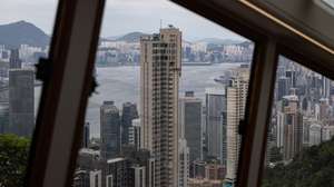epa10135663 Residential and commercial buildings stand on Hong Kong island and the Kowloon Peninsula as seen from the 6th Generation Peak Tram during an unveiling press preview trip in Hong Kong, China, 24 August 2022. The Peak Tram cars will open to the public on 27 August 2022, after an upgrade project that included the replacement of all haulage, control and signalling systems, ropes and track trails. The new Peak Tram has been manufactured in Switzerland by Garaventa and comprises two cars with a capacity of 210 passengers.  EPA/JEROME FAVRE