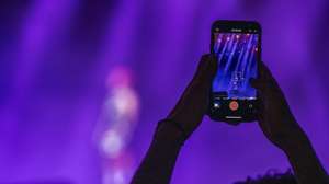 epa12203836 A music-goer takes a video clip with a smartphone of Moroccan rapper ElGrandeToto performing during the Mawazine international music festival on the OLM Souissi stage in Rabat, Morocco, 28 June 2025.  EPA/JALAL MORCHIDI