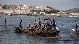 epa09209430 Migrants arrive swimming to cross the border of Tarajal in Ceuta, Spain, 18 May 2021. On the night of 17 May, a total of 5,000 Moroccan nationals entered into the Spanish city of Ceuta, loacted in the North African coast, by sea side and hundreds of migrants continue to attempt doing so. The Spanish authorities have deployed the army to patrol on the border separating Ceuta in the Spanish side from the Moroccan side, in a bid to control this latest surge of entry attempts.  EPA/BRAIS LORENZO