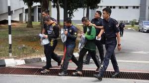 epa11613134 Royal Malaysian Police officers escort three members of Global Ikhwan Services and Business Holdings (GISBH) as they depart after facing charges at a court in Seremban, Malaysia, 19 September 2024. The three suspects, detained during recent operations involving the raid of 20 welfare homes allegedly linked to GISBH, will be charged under Sections 14(a) and 14(b) of the Sexual Offenses Against Children Act 2017 (Act 792). The raid resulted in 171 arrests for 'neglect and mistreatment' of children, according to a police statement from 11 September.  EPA/FAZRY ISMAIL