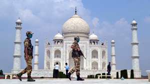 epa08685840 Indian security personnel stand guard at the Taj Mahal in Agra, Uttar Pradesh, India, 21 September 2020. The Taj Mahal reopened with increased safety measures after it was closed down by the authorities for six months amid the COVID-19 pandemic.  EPA/STR