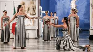 epa12549789 A handout photo made available by Presidency of the Hellenic Republic shows Greek actress Mary Mina (L), playing the role of High Priestess, lighting the flame during the Olympic flame lighting ceremony for the Milano Cortina 2026 Winter Olympics at the Archaeological Museum of Olympia, in southern Greece, 26 November 2025. The Milano Cortina 2026 Winter Olympics will be held from 06 February to 22 February 2026.  EPA/THODORIS MANOLOPOULOS HANDOUT HANDOUT EDITORIAL USE ONLY/NO SALESHANDOUT EDITORIAL USE ONLY/NO SALES