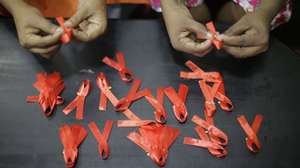 epa08037313 Princy Mangaika, Executive Director of Positive Women's Network (PWN), herself an HIV infected patient and another female make AIDS awareness ribbons at her residence in Colombo, Sri Lanka 01 December 2019. Mangalika, a mother of two acknowledges that she contracted the Human Immunodeficiency Virus (HIV) in 1999 from her spouse who had worked overseas and identified as positive in 2000, and says that those in her village had set their home on fire when they became aware of their illness. Without giving up hope, she has continued to assist in awareness-raising and also runs a care center for several AIDS patients. Currently, her organization WomenÕs Network (PWN) has 586 members including 44 children. Several events were held in Colombo to coincide with World AIDS Day on 1st December. The estimated number of people infected with HIV in Sri Lanka is around 3500 to - 4200 by 2018, but only around two-thirds of them know that they have HIV, according to the National STD/AIDS Control Programme (NSACP) of the Ministry of Health, Sri Lanka. The island nation aims to completely eradicate Human Immunodeficiency Virus (HIV) and the Acquired Immunodeficiency Syndrome (AIDS) by the year 2030.  EPA/Chamila Karunarathne