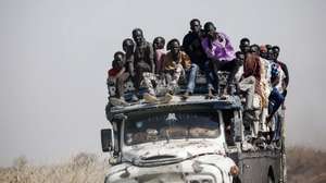 epa11000674 epa10622722 Sudanese refugees and South Sudanese returnees travel atop a truck transporting them from the border towards the Upper Nile State town of Renk, South Sudan, 12 May 2023. Fleeing the armed conflict between the Sudanese military and the RSF (Rapid Support Forces) militia which started last 15 April, some 40 000 people have arrived into South Sudan according to the UNHCR. Most of the refugees are part of the some 800 000 South Sudanese who had fled the war in South Sudan in the first place and they are returning to a country which is barely out of conflict itself with tensions still remaining in many areas and more than 2 million internally displaced people. The scarcity of food and water and the military escalation had made the stay of most civilians impossible in Sudan. Upon arriving at Joda border crossing the refugees head to a transit area set up by the UNHCR in the small town of Renk, where various UN agencies assist them with registration, food, health check and logistics to either leave Renk which is not equipped to house a large refugee population.  EPA/AMEL PAIN  EPA-EFE/AMEL PAIN