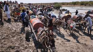 epa11898825 Sudanese refugees wait their turn to get drinking water from a muddy pond in Gerbana, a village 22km from the Sudanese border, South Sudan, 13 February 2025 (issued on 15 February 2025), as  water shortages and diseases resulting from contaminated water have become the community's main complaint. About 110,000 people have arrived in Renk County since December 2024, according to MSF, with 70,000 living in informal settlements such as Gerbana and Atham. There are 975,079 Sudanese refugees in South Sudan, according to UNHCR.  EPA/DIEGO MENJIBAR