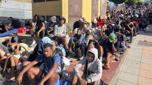 epaselect epa13190329 Migrants wait outside temporary shelter set up at Loma Colmenar in Ceuta, Spain, 25 August 2026. Spain faced a massive migration crisis after thousands of people crossed into the North African enclave of Ceuta from Morocco in late July 2026.  EPA/Reduan