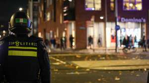 epa11715448 Anti riot police stand guard at the scene after a group caused a commotion on Plein 40-45 in Amsterdam Nieuw-West, The Netherlands, 11 November 2024. In the disturbances, a burning object landed on a streetcar and caught fire, but was extinguished. There were no people in the streetcar and no injuries were reported.  EPA/TALHA ANDAC