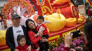 epa10421877 A Chinese family poses for photos next to a rabbit lantern to celebrate the Chinese lunar new year in Macau, China, 22 January 2023. Macau borders reopened earlier this month and the city has launched a promotional campaign to boost tourism, offering Hong Kong residents a 'half-price' round-trip if travellers spend a night there during the Chinese Lunar New Year period. The Chinese lunar new year, also called 'Spring Festival', falls on 22 January 2023, marking the beginning of the Year of the Rabbit.  EPA/JEROME FAVRE
