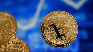 epa09018336 A bitcoin reflects in front of a monitor showing a stock barometer in Duesseldorf, Germany, 17 February 2021. For the first time, the cryptocurrency Bitcoin has exceeded the mark of 50,000 dollars. Most recently, it became known that Elon Musk, CEO of the US electric car manufacturer Tesla, is said to have invested 1.5 billion dollars in Bitcoin. In recent weeks, he had boosted Bitcoin as well as other Internet currencies with positive news via the short message service Twitter. Credit card provider MasterCard also announced that it would open its payment network to cryptocurrencies. Visa plans to help banks introduce trading with Bitcoin and other cryptocurrencies by launching software with API access.  EPA/SASCHA STEINBACH