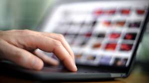 epa08473196 A person sits in front of a computer screen showing many small photos and holds a computer mouse in his hand, in Duisburg, Germany, 08 June 2020. According to the investigators, the case of child sex abuse ring in Muenster, with three victims and eleven suspects, seven of whom are in custody, is characterized by its highly professional technical equipment for video recording and data encryption. Abuse offenders adapt to the possibilities, but also to the dangers of detection and professionalize themselves on the net, according to police investigators. In 2019 there were more than 12,000 investigations and criminal proceedings in Germany for so-called child pornography.  EPA/SASCHA STEINBACH