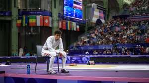 epa11524675 Zwei Mo of China waits judges&#039; decision during his bout with Enzo Lefort of France at the Men Foil Team Table of 8 competition in the Paris 2024 Olympic Games, at the Grand Palais in Paris, France, 04 August 2024.  EPA/MARTIN DIVISEK