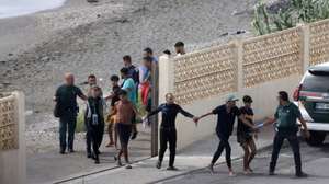 epa11565244 Members of the Spanish Guardia Civil (Civil Guard) detain migrats who have just entered Ceuta, Spanish enclave in the North of Africa, 26 August 2024. Since 25 August, migrants have been entering Spanish territory through Ceuta&#039;s beaches, taking advantage of thick fog in the area.  EPA/REDUAN ATTENTION EDITORS: IMAGE PIXELATED AT SOURCE TO COMPLY WITH SPANISH LAW