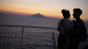 epa08615247 A couple enjoys the sunset on the deck of the ferry boat 'Nissos Mykonos', while sailing in the Aegean sea, Greece, 20 August 2020.  EPA/DIMITRIS TOSIDIS