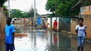 Populares caminham numa rua alagada do Bairro da Boa Esperança após a queda de chuvas fortes na capital angolana, Luanda, Angola, 9 de abril de 2019.  AMPE ROGÉRIO/LUSA