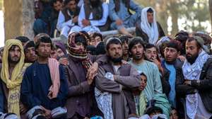 epa12009936 Afghan people watch as wrestlers fight at a makeshift wrestling arena in Kabul, Afghanistan, 04 April 2025. Spectators gathered to support their favorite wrestlers from provinces like Herat, Nimroz, Kandahar, Zabul, and Farah during these unofficial competitions, which are often held in celebration of the spring holidays and Nowruz.  EPA/SAMIULLAH POPAL