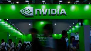 epa12118553 People walk past the NVIDIA booth during the COMPUTEX 2025 Exhibition show in Taipei, Taiwan, 20 May 2025. Computex 2025, one of the largest computer and technology trade shows in the world, runs from 20 to 23 May in Taipei.  EPA/RITCHIE B. TONGO