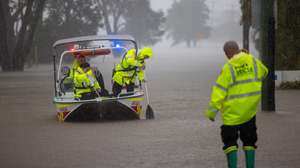 epaselect epa12124624 NSW Fire Rescue personnel assist an elderly resident during flooding in Port Macquarie, New South Wales, Australia, 22 May 2025. A slow-moving trough is dumping rain along the east coast of Australia, leaving thousands of people stranded.  EPA/Lindsay Moller AUSTRALIA AND NEW ZEALAND OUT
