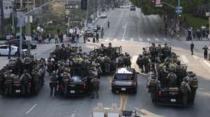 epa12167309 Police fill the street as they face off with protesters in Los Angeles, California, USA, 09 June 2025. Approximately 2,000 National Guard troops were deployed on 08 June in Los Angeles by US President Donald Trump, though the state of California had not requested any additional assistance, and protests have continued against the Trump administration's immigration enforcement raids over the last couple of days.  EPA/CAROLINE BREHMAN