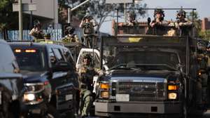 epaselect epa12167245 Members of the California National Guard keep watch on protesters near the Edward R. Roybal Federal Building in Los Angeles, California, USA, 09 June 2025. Approximately 2,000 National Guard troops were deployed on 08 June in Los Angeles by US President Donald Trump, though the state of California had not requested any additional assistance, and protests have continued against the Trump administration's immigration enforcement raids over the last couple of days.  EPA/ALLISON DINNER
