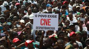 Demonstrators hold a poster 'The People Demand a Dispartisan CNE' during a march for the pacification of Angola, called by National Union for the Total Independence of Angola (UNITA), in Luanda, Angola, 24 September 2022. The National Union for the Total Independence of Angola (UNITA) promotes today, one month after the Angolan elections, a march in defense of the democratic state and the rule of law and for the release of political prisoners. AMPE ROGERIO/LUSA