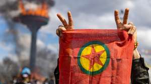epa11978437 Supporters of The Peoples' Equality and Democracy Party (DEM) hold a flag of the Kurdistan Workers' Party (PKK), and shout slogans next to a bonfire during a rally for Newruz celebrations in Diyarbakir, Turkey, 21 March 2025. Newroz or Nowruz, which means 'new day' in the Persian language, marks the arrival of spring and the first day in the Iranian calendar. It is widely celebrated in the Persian and neighboring regions and recognized on the UNESCO List of the Intangible Cultural Heritage of Humanity.  EPA/METIN YOKSU