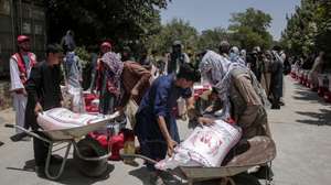 epa12209051 Afghan refugees returning from Iran receive food rations during a ceremony in Kabul, Afghanistan, 01 July 2025. The Afghan Red Crescent, distributed food and non-food items to 200 needy families, including returnees from Iran, in an event attended by officials from the organization and the Silab Charity Foundation. The Afghan Red Cross has urged for increased global aid for returnees, citing the return of over 800,000 Afghans from Iran in the past six months and highlighting the dire conditions faced by these individuals.  EPA/SAMIULLAH POPAL