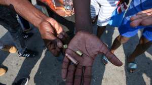 epa11943043 Protesters show empty shell cases used by police to disperse a march in Maputo, Mozambique, 05 March 2025. Mozambican police used live bullets to disperse the march by opposition leader Venancio Mondlane, former presidential candidate for Mozambique's Optimistic Party for the Development of Mozambique (PODEMOS).  EPA/REGULO CUNA