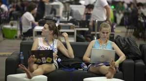epa04602613 Two participants, "campuseros", work on their computers during the 8th edition of Brazil's Campus Party, in Sao Paulo, Brazil, 03 February 2015. The Campus Party is an important international event in the areas of Internet, Innovation, Creativity and Science, which for six days brings together thousands of young people around these issues, which runs from 03 to 08 February in Sao Paulo.  EPA/SEBASTIAO MOREIRA