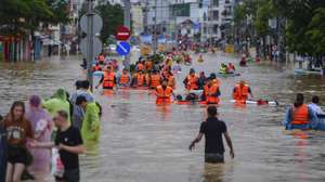 epa12539407 People wade through flood water in Nha Trang, Khanh Hoa province, Vietnam, 20 November 2025 (issued on 21 November 2025). At least 40 people were killed after torrential rain and flooding in four provinces in southern and central Vietnam, state media reported.  EPA/STRINGER