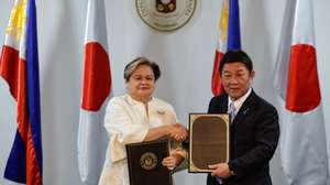 epa12650344 Philippines Foreign Affairs Secretary Ma. Theresa Lazaro (L) and Japan Foreign Minister Toshimitsu Motegi (R) hold signed agreement documents following a bilateral meeting in Pasay City, Metro Manila, Philippines, 15 January 2026. The two officials met to boost mutual cooperation and mark 70 years of normalization of diplomatic relations between the Philippines and Japan.  EPA/ROLEX DELA PENA