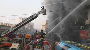 epa12658504 Firefighters battle a massive blaze at Gul Plaza in Karachi, Pakistan, 18 January 2026. At least six people were killed and around 20 injured after a fire swept through Gul Plaza shopping mall, housing about 1,200 shops. Part of the building collapsed, hampering rescue efforts, as firefighters struggled to control the blaze.  EPA/SHAHZAIB AKBER