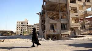 epaselect epa13011954 An Iranian woman walks past a residential building, destroyed by previous US-Israeli airstrikes, in Tehran, Iran, 02 June 2026. The Iranian Foreign Minister stated that the agreement between Iran and the US is 'a ceasefire on all fronts, including in Lebanon,' warning that its breach on one front constitutes a 'violation of the ceasefire on all fronts.'  EPA/ABEDIN TAHERKENAREH RESTRICTIONS: NO Access Israel Media/Persian Language TV Stations Outside Iran/Strictly No Access BBC Persian/VOA Persian/Manoto TV/Iran International TV. (As mandated by Iran's Directorate General for Foreign Media) --