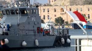 epa07504163 The migrants on board the Maltese Armed Forces P51 vessel, rescued at sea within Malta's Search and Rescue Region from the German-flagged NGO rescue vessel Alan Kurdi, arrive at the Armed Forces of Malta maritime base at Hay Wharf, in Floriana, Malta, 13 April 2019. Malta has announced a deal to distribute among four EU nations the 64 migrants rescued at sea off Libya 10 days earlier.  EPA/DOMENIC AQUILINA
