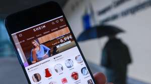 epa12749291 The Shein website is displayed on a smartphone in front of the European Commission headquarters in Brussels, Belgium, 17 February 2026. The European Commission is expected to provide a formal update on its investigation into Shein under the Digital Services Act (DSA).  EPA/Olivier Hoslet