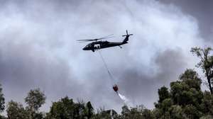 epaselect epa13050469 A helicopter conducts water drops over an active wildfire in the Everglades as fires continue to burn west of Miami, Florida, USA, 19 June 2026. Wildfires in the Everglades have scorched thousands of acres, blanketing parts of South Florida with smoke and causing road closures as firefighters continue containment efforts. Officials believe a lightning strike may have ignited the fire, with severe drought conditions contributing to its rapid spread.  EPA/CRISTOBAL HERRERA-ULASHKEVICH