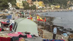 epa13216498 A migrant stands near makeshift tents erected by migrants along Trampolin Beach in Ceuta, Spain, 06 September 2026. Ceuta President Juan Jesus Vivas is expected to meet European Commissioners Magnus Brunner and Dubravka Suica and European Parliament President Roberta Metsola in Brussels on 08 September to discuss the migration crisis. Thousands of people crossed from Morocco into the Spanish North African enclave in late July 2026.  EPA/REDUAN