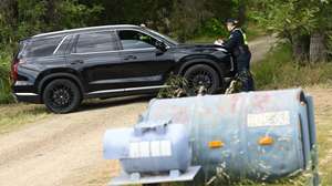 epa13316217 A police car blocks a dirt road off the Great Alpine Road near Tarrawingee, Australia, 20 October 2026. Independent federal MP Helen Haines was critically injured after being struck by a vehicle outside her electorate office in Wangaratta on 19 October. A 43-year-old man from Tarrawingee remains in police custody, according to the Australian Federal Police.  EPA/JAMES ROSS AUSTRALIA AND NEW ZEALAND OUT