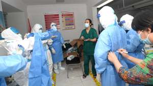 epa09392200 Medical workers prepare to take swab samples for the mass Covid-19 test in a residential block in Wuhan, Hubei province, China, 03 August 2021. Wuhan, the epicenter of the coronavirus outbreak, is testing all of its eleven million residents for the Sars-CoV-2 coronavirus after seven new infections were registered, a city official said as quoted by several media.  EPA/SHEPHERD ZHOU CHINA OUT