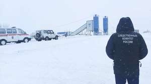 epa09602102 A handout photo made available by the Russian Investigative Committee (Sledcom) shows an investigator in front of the Listvyazhnaya coal mine near the town of Gramoteino in the Kemerovo region, Russia, 25 November 2021. Coal dust exploded in the ventilation system of the coal mine; at the time of the accident, there were 285 miners in the mine, and 11 miners were found dead.  EPA/YURI KOCHETKOV / HANDOUT  HANDOUT EDITORIAL USE ONLY/NO SALES