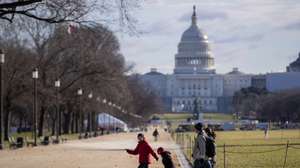 epa07245307 A family walks on the National Mall near the US Capitol in Washington, DC, USA, 22 December 2018. A partial US government shutdown began at midnight when a funding agreement between Congress and US President Donald J. Trump could not be reached.  EPA/ERIK S. LESSER
