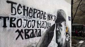 epa09660486 Joggers run past a mural depicting former Bosnian Serb military chief Ratko Mladic in Belgrade, Serbia, 30 December 2021. The mural was painted in July 2021, shortly after the former head of Serb troops in Bosnia was sentenced by the International Court of Justice (ICJ) to life imprisonment as he was found guilty for the massacre of some 8,000 Muslims in Srebrenica (Bosnia) and other war crimes. "The ethnocentric approach to the past is dominant in all former Yugoslav republics, and both victims and criminals are always 'ours' and 'theirs,' depending on the ethnicity to which they belong," says Isidora Stakic of the NGO Humanitarian Law Fund. According to Stakic, the fact that the graffiti is still there proves historical revisionism and denial of the facts proven in the trials. The Serbian government argues that erasing the mural is the responsibility of the municipality.  EPA/ANDREJ CUKIC