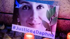 epa09031963 (FILE) - 'Justice four Daphne' is written on a cardboard showing a photo of Daphne Caruana Galizia, during a picket in front of the Maltese embassy for murdered journalist Daphne Caruana Galizia in Berlin, Germany, 16 October 2019 (reissued 23 February 2021). More than three years after the murder of journalist Daphne Caruana Galizia in Malta, a court has sentenced one of three defendants to 15 years in prison, after he admitted to the killing, media in Malta reported. Maltese journalist Daphne Caruana Galizia was killed on 16 October 2017 in Malta, while investigating the Panama Papers case.  EPA/CLEMENS BILAN *** Local Caption *** 55553937