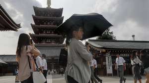 epa06909239 A woman uses her parasol as she walks past the five-story pagoda at the Sensoji temple in downtown Tokyo, Japan, 25 July 2018. In central Tokyo, the temperature rose to 32.2 degrees Celsius, 3.2 degrees lower than the previous day, and Yamaguchi City marked 38.8 degrees Celsius. Typhoon Jongdari, currently in the Pacific Ocean, is moving northward and reducing the heatwave affecting Japan and will possibly make direct landfall on Tokyo and Japan's main island of Honshu on the weekend.  EPA/KIMIMASA MAYAMA