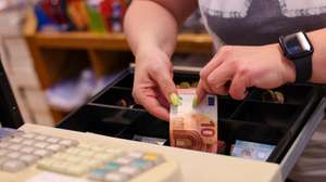 epa10842715 A saleswoman reaches into a cash register and gives change at a store in Essen Germany, Germany, 05 September 2023. According to German government statistics, food prices in July 2023 were on average 11 percent higher compared to the same period in 2022. Various German welfare organizations reported in 2022 that 13.8 million people in Germany lived in poverty or were at risk of being below the poverty line.  EPA/Christopher Neundorf